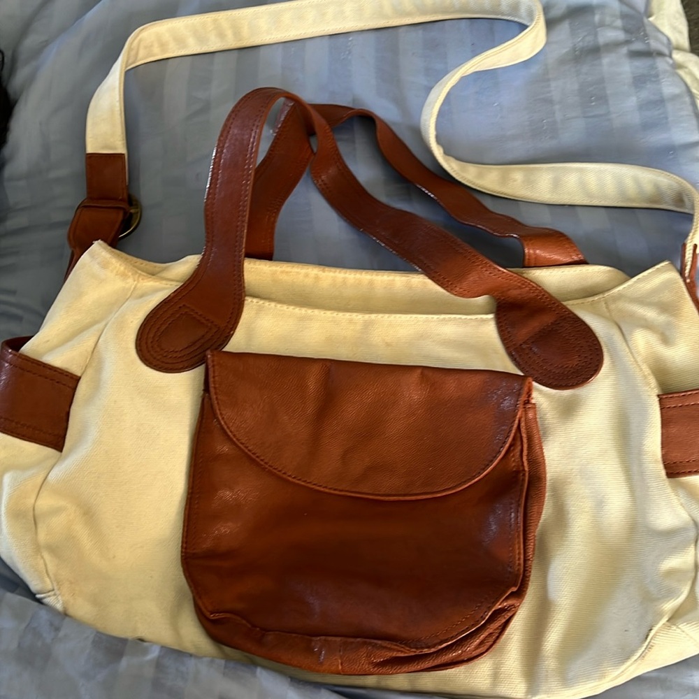 Michael Stars hand bag made of heavy cloth and golden brown leather.